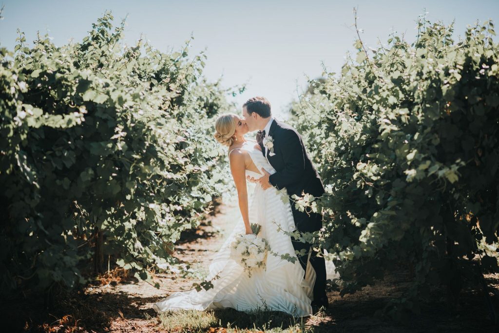 The Willow Ballroom couple kissing in the vineyard