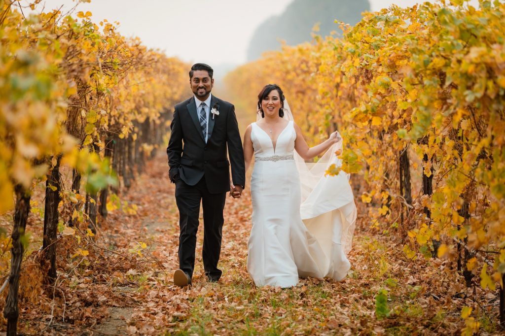The Willow Ballroom couple walking through golden vineyards