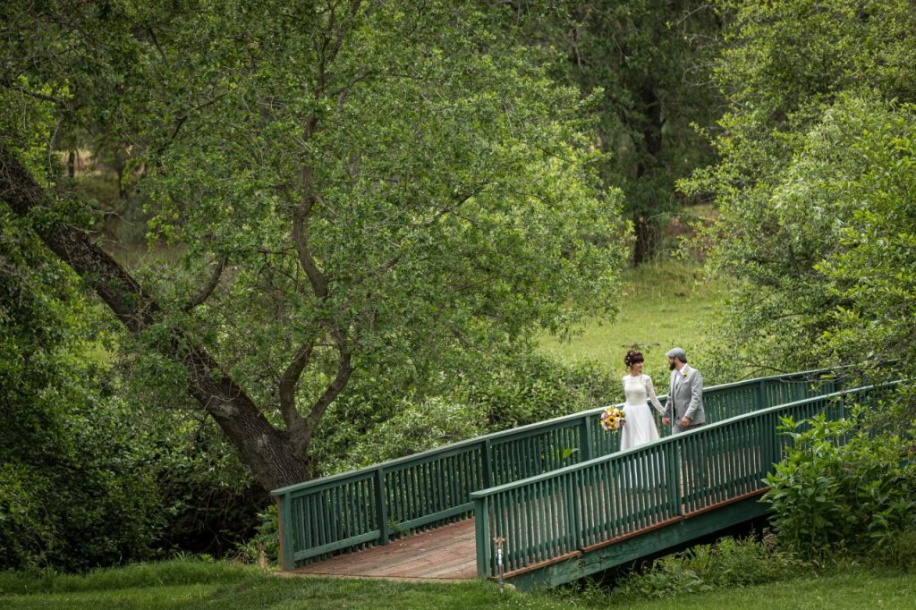 Gold Hill Gardens, Placer County, CA Newlyweds crossing the footbridge.