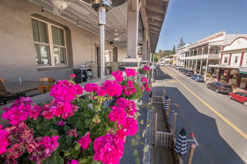 Hotel Sutter, Sutter Creek, CA. Balcony with flowers blooming on railing.