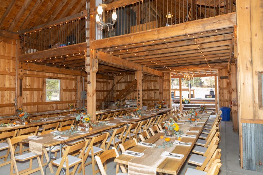Vida Buena Farm, Calaveras County in gold country. Long tables set for 120 people inside the barn.