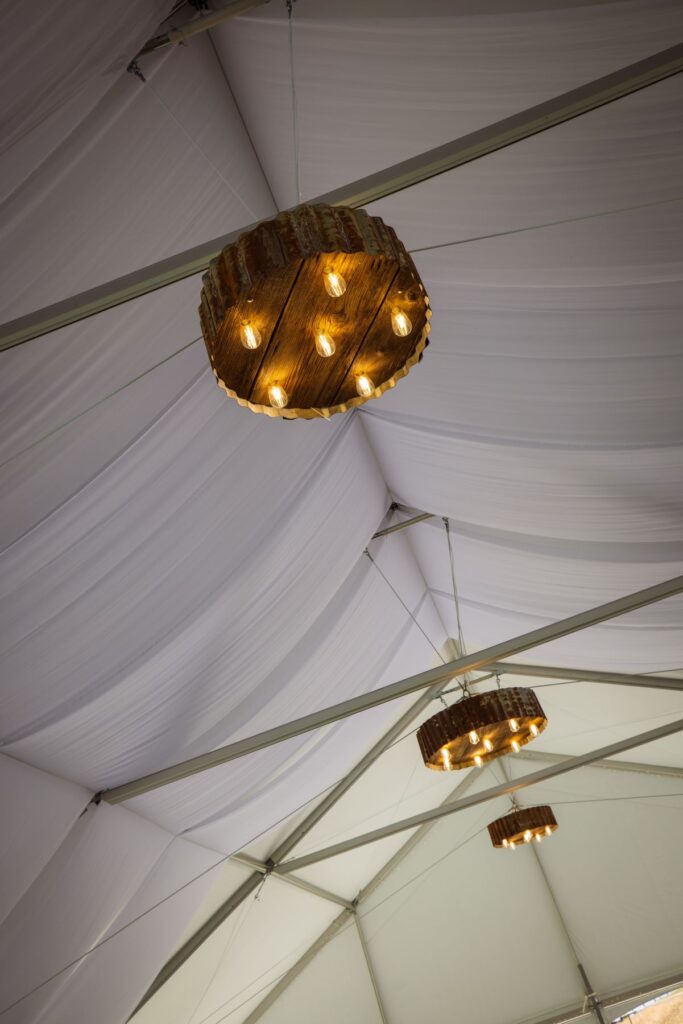 Crossing at Thomes Creek Wedding Events. Rustic wheel light fixtures.