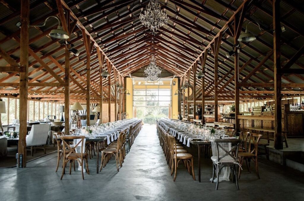 Kate Whelan Events, Sacramento. Tables inside barn structure